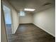 View of the spacious basement area featuring dark wood flooring and a window at 2322 Rock Mill Ne Ln, Conyers, GA 30013