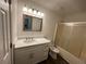 Modern bathroom with vanity, well-lit mirror, and a shower tub at 2322 Rock Mill Ne Ln, Conyers, GA 30013