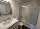 Cozy bathroom featuring updated vanity, modern fixtures, and a shower-tub combo at 2322 Rock Mill Ne Ln, Conyers, GA 30013