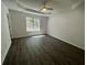 Light-filled bedroom with a ceiling fan, fresh paint, and stylish flooring at 2322 Rock Mill Ne Ln, Conyers, GA 30013