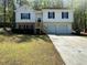Charming home featuring a manicured lawn, two-car garage, and inviting front porch at 2322 Rock Mill Ne Ln, Conyers, GA 30013