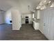 Well-lit kitchen featuring stainless appliances, bright cabinetry and a view of the living space at 2322 Rock Mill Ne Ln, Conyers, GA 30013