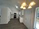 Well-lit kitchen featuring stainless appliances, bright cabinetry, and modern lighting at 2322 Rock Mill Ne Ln, Conyers, GA 30013