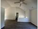 Bright, vaulted living room featuring modern lighting, fresh paint, and gorgeous flooring at 2322 Rock Mill Ne Ln, Conyers, GA 30013