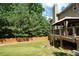 View of backyard, deck with gazebo, green lawn, and a wooden fence at 3070 Jardin Nw Ln, Kennesaw, GA 30152