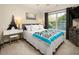 Bright bedroom with a queen bed, neutral walls, and a sunny window providing natural light at 3070 Jardin Nw Ln, Kennesaw, GA 30152