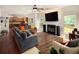 Cozy living room with a fireplace, hardwood floors, and ample natural light at 3070 Jardin Nw Ln, Kennesaw, GA 30152