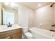 Modern bathroom featuring a wood vanity, quartz countertop, and a tub/shower combo at 3962 Adler Cir, Buford, GA 30519
