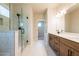 Bathroom featuring a double sink vanity and glass enclosed shower with black hardware at 3962 Adler Cir, Buford, GA 30519