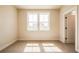 Well-lit bedroom featuring carpet floors and a large double-hung window at 3962 Adler Cir, Buford, GA 30519