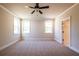 Spacious bedroom features new carpet, a ceiling fan, and white trim at 3962 Adler Cir, Buford, GA 30519