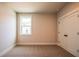 Bedroom with neutral carpet and walls, a double door closet, and natural light at 3962 Adler Cir, Buford, GA 30519
