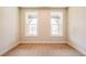 Bedroom with neutral carpet and two windows at 3962 Adler Cir, Buford, GA 30519