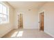 Bright bedroom featuring neutral carpet, a large window, and a walk-in closet at 3962 Adler Cir, Buford, GA 30519