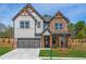 Charming two-story home featuring a mix of brick and gray siding, and inviting covered entryway at 3962 Adler Cir, Buford, GA 30519