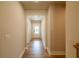 Bright hallway with hardwood floors leading into the home, and an entry door at the end at 3962 Adler Cir, Buford, GA 30519