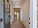 Bright hallway with hardwood floors leading into the home, and a view of the staircase at 3962 Adler Cir, Buford, GA 30519