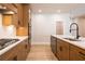 Modern kitchen with stainless steel appliances, wooden cabinets, and light countertops at 3962 Adler Cir, Buford, GA 30519
