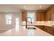 Open kitchen with an island, a modern sink, and lots of wooden cabinets at 3962 Adler Cir, Buford, GA 30519