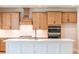 Well-lit kitchen with a large island, wooden cabinets, and stainless steel appliances at 3962 Adler Cir, Buford, GA 30519