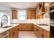 Well-lit kitchen with stainless steel appliances, light countertops, and wooden cabinets at 3962 Adler Cir, Buford, GA 30519