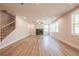 Open living room features a modern fireplace, staircase to the left, and hardwood floors at 3962 Adler Cir, Buford, GA 30519
