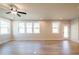 Bright, open living room with hardwood floors, recessed lighting, ceiling fan, and an outdoor view at 3962 Adler Cir, Buford, GA 30519