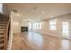 Spacious living room features a modern fireplace, large windows, and hardwood floors at 3962 Adler Cir, Buford, GA 30519