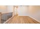 Open loft space with wood flooring, natural light, and a wooden stair rail at 3962 Adler Cir, Buford, GA 30519