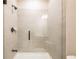 Modern tiled shower with a sleek glass door and oil rubbed bronze shower head and fixtures at 3962 Adler Cir, Buford, GA 30519