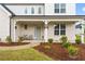Inviting front porch with seating and manicured landscaping at 137 Bastian Rd, Mcdonough, GA 30252