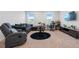 Comfortable living room with a sectional sofa, recliner, round table, desk and media console at 137 Bastian Rd, Mcdonough, GA 30252