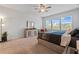 Airy main bedroom with a ceiling fan, dresser, and windows offering neighborhood views at 137 Bastian Rd, Mcdonough, GA 30252