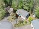 Aerial view of a home with mature trees, a two-car garage, and a well-maintained lawn at 1842 Jarrett Dr, Lawrenceville, GA 30043