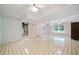 Spacious basement with tile floors, two ceiling fans, and natural light from the windows at 1842 Jarrett Dr, Lawrenceville, GA 30043