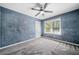 Bedroom with blue textured walls, carpet, a ceiling fan, and a window at 1842 Jarrett Dr, Lawrenceville, GA 30043