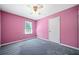 Cozy bedroom featuring pink walls, grey carpet and a ceiling fan at 1842 Jarrett Dr, Lawrenceville, GA 30043