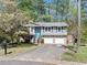 Charming two-story home with stone accents, a blue front door, and a well-manicured lawn at 1842 Jarrett Dr, Lawrenceville, GA 30043