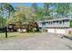Charming home with stone accents, lush landscaping, and a long driveway leading to a two-car garage at 1842 Jarrett Dr, Lawrenceville, GA 30043