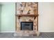 Stone fireplace with wooden mantel creates a cozy and inviting focal point in the living area at 1842 Jarrett Dr, Lawrenceville, GA 30043