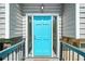 Vibrant turquoise front door with glass sidelights enhances curb appeal with inviting entry at 1842 Jarrett Dr, Lawrenceville, GA 30043