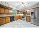 Spacious kitchen with stainless steel refrigerator, wood cabinets and tile floors at 1842 Jarrett Dr, Lawrenceville, GA 30043