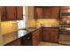 Well-lit kitchen featuring granite countertops, stainless steel sink and modern backsplash at 1842 Jarrett Dr, Lawrenceville, GA 30043