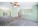 Open living room featuring neutral paint, plush carpeting, and a stylish ceiling fan with lighting at 1842 Jarrett Dr, Lawrenceville, GA 30043