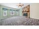 Open living room featuring stone fireplace, and bright windows with natural light at 1842 Jarrett Dr, Lawrenceville, GA 30043