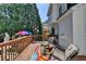Relaxing back deck area with comfortable seating, colorful umbrella, and a peaceful backyard view at 2123 Floral Ridge Dr, Dacula, GA 30019