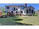 Expansive backyard featuring a charming deck, lush lawn and mature landscaping at 2123 Floral Ridge Dr, Dacula, GA 30019