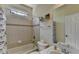 Bright bathroom featuring a shower-tub combo with beige tile, and a white sink and toilet at 2123 Floral Ridge Dr, Dacula, GA 30019