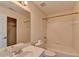 Bright bathroom featuring a bathtub, toilet, and vanity with a mirror reflecting the walk-in closet at 2123 Floral Ridge Dr, Dacula, GA 30019