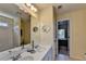 Well-lit bathroom featuring a double sink vanity, a mirror, and a bathtub and shower at 2123 Floral Ridge Dr, Dacula, GA 30019